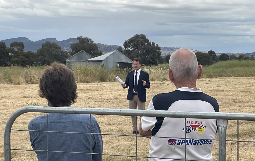Auctioneer Lachlan Hutchins at the 13-hectare Table Top block. Picture by Ted Howes