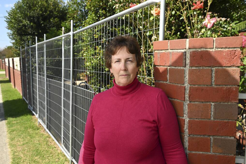 Maree Stanford outside her wall which was knocked down last year after a car smashed into it after exiting the nearby Kotthoff Street, McDonald Road roundabout. Picture by Mark Jesser