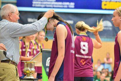 Wodonga talent Lily-Anne McClure is presented with her gold medal at the Country Cup after winning the grand final with Victorian Bushrangers' under-16 side.