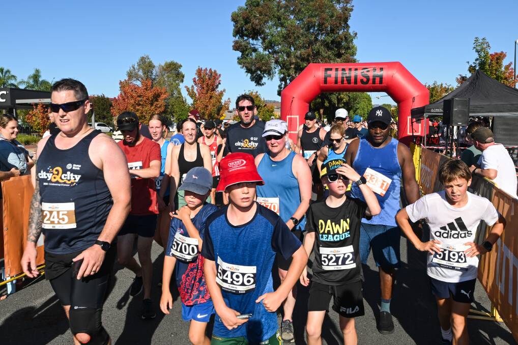 Some tired runners crossing the finish line at Junction Place, Wodonga. Picture by Mark Jesser