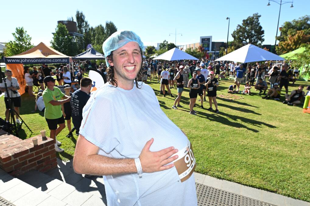 Nurse Cameron Littlewood ran the 15km event with a fake pregnancy belly. Picture by Mark Jesser
