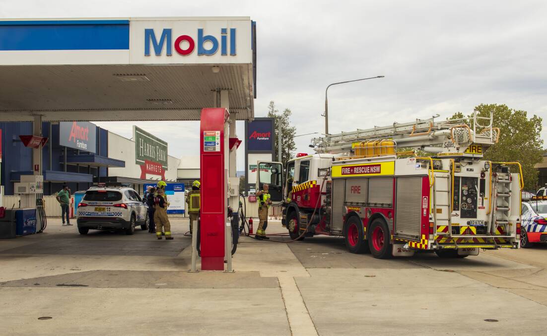 Police and fire crews at the Mobil service station on the corner of Guinea and Young Street, Albury. Picture by Layton Holley