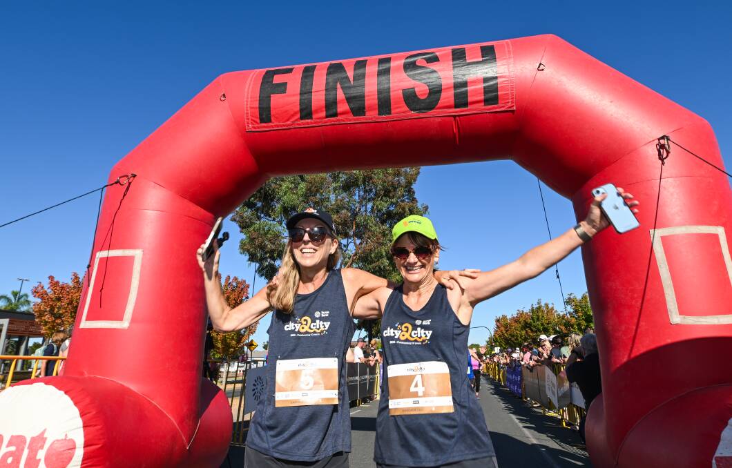 Organisers Jen Hayes and Michelle Hudson crossing the finish line at Junction Place, Wodonga. Picture by Mark Jesser