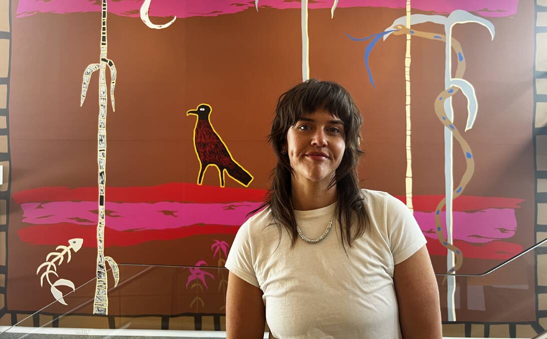 Wiradjuri artist Bethany Thornber with her latest work, It's flamin hot darl. Picture supplied