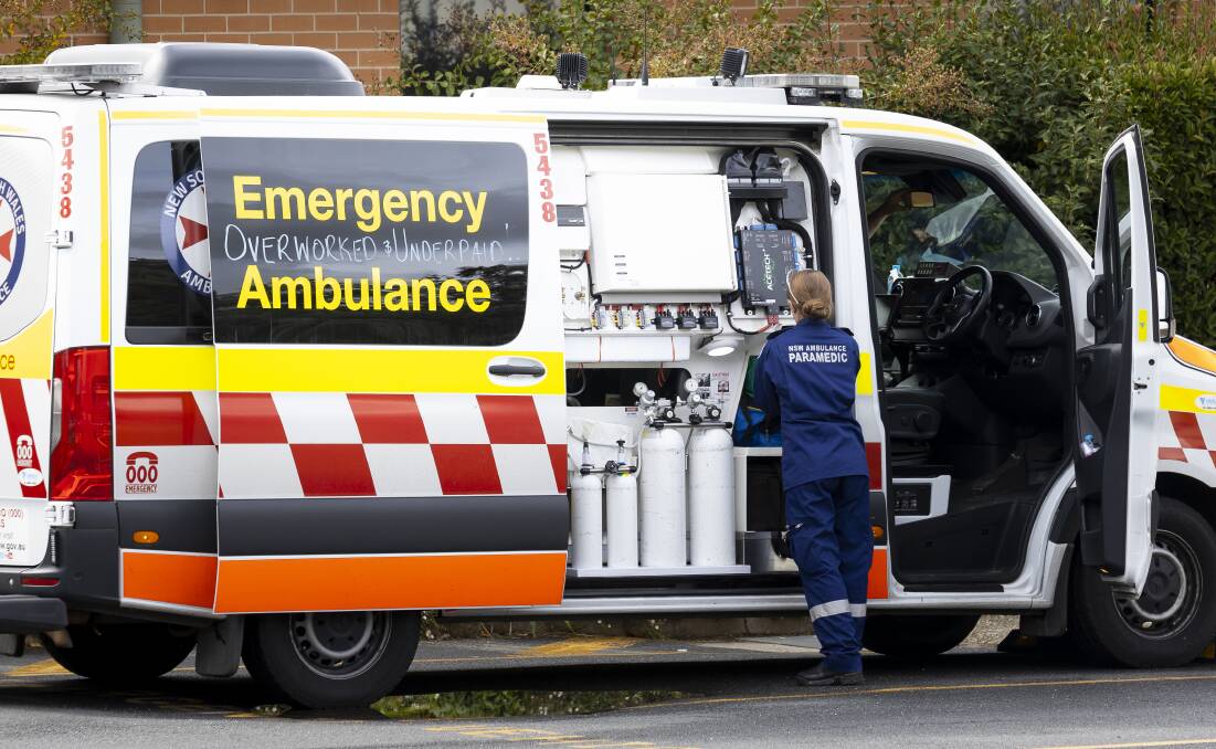 NSW Ambulance with the words "overworked and underpaid" written on the side. File image