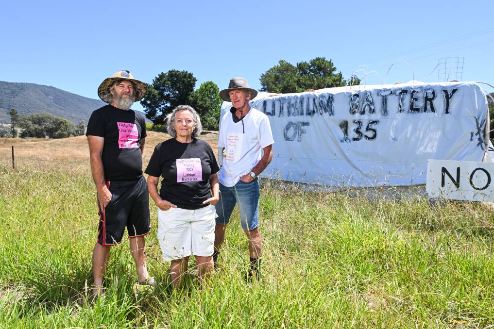 Dederang residents Will Deuchar, Sue Fisher-Smith and John McEvoy with a fake battery in a paddock on the way into town. Picture by Mark Jesser 