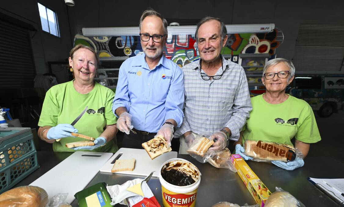 Carevan volunteers Barb Anne and Heather Webb prepare school lunches with Albury West Rotary Club's Bill Smits and Bruce Dwerryhouse. Picture by Mark Jesser