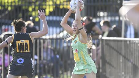 North Albury's Madi Lieschke looks to move the ball down the court under the defensive pressure of Albruy's Heidi Fisher during the clubs' Anzac Day clash at the Albury Sportsground. Picture by Mark Jesser.