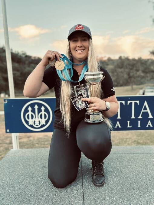 Border clay target shooter Emalene Munro with her medal and trophy after recently placing first at the Oceania Championships in Mudgee, NSW. Picture supplied.