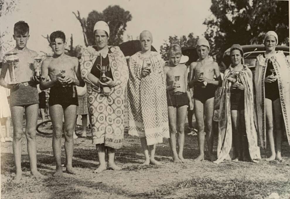 SPLASH OF MODESTY: St Augustines School swimming champions at the Wodonga Creek in 1940. The nuns required the girls to wear their towels out of the water.