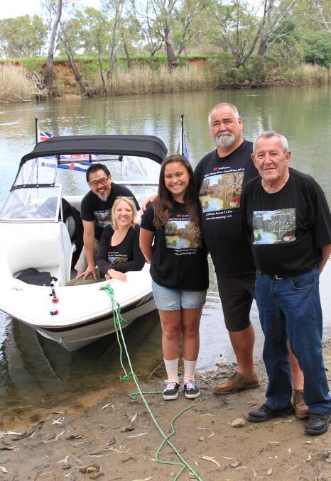 JOURNEY: Dianne Yoong sits with her husband Kiam in their boat River Spirit alongside daughter Jasmine and her support team before leaving. Pictures: DAVIS HARRIGAN