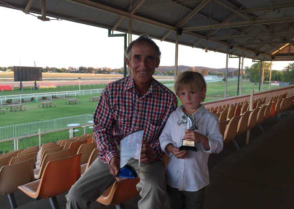 HAPPY DAYS: Gundagai trainer David Blundell and four-year-son Denver show off Itsa Fait Accompli's 3YO Horse of the Year trophies at the SDRA Awards on Murrumbidgee Turf Club on Wednesday night. Picture: Matt Malone