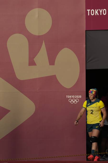 LEARNING EXPERIENCE: Batlow's Sharni Williams leads the Australian women's rugby sevens team onto the field against China in Tokyo. Picture: PA