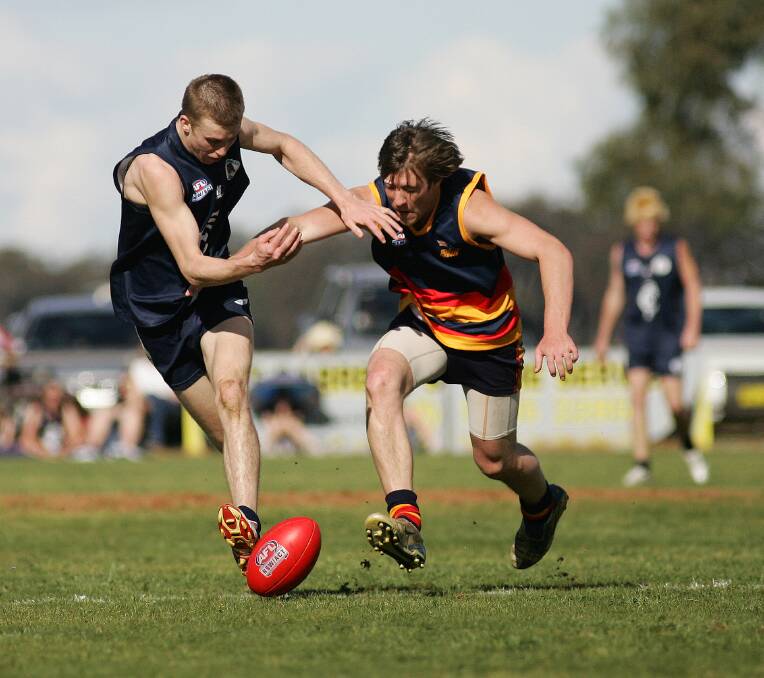 ON BALL: Billabong Crows' Tyral Dalitz under pressure from Coleambally's Tom Groves in Coreen League finals in 2007.
