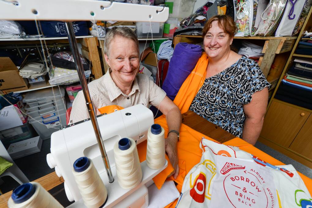 SEW LONG: Boomerang Bags Albury Wodonga volunteers Veronica Kohne and Sharan Moore at a sewing bee last year at The SAC, which has now closed at Gateway Village.