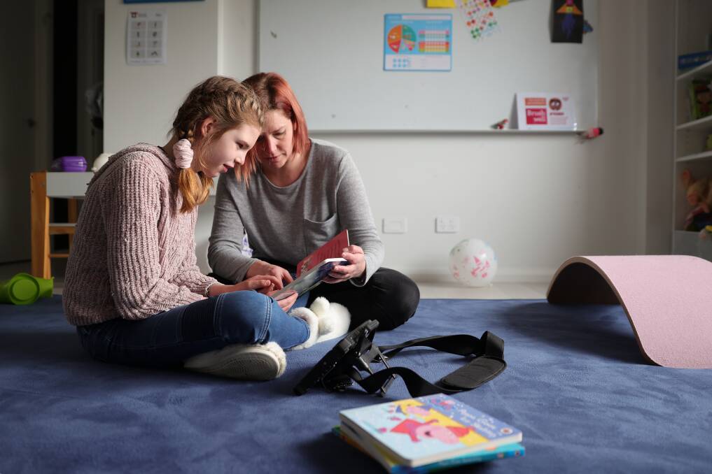 HER VOICE: Melanie Stephens with her daughter Ella, 11, who relies on a talker device to communicate with her family. Pictures: JAMES WILTSHIRE