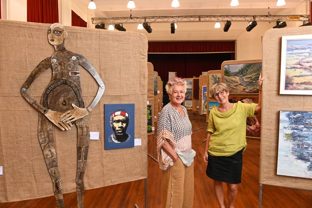 ART PRIZE: Irena Webster and Joy Schmidt look over some of the more than 500 entries in the Rutherglen Tastes of Art Prize. The exhibition at the Rutherglen Memorial Hall runs today until Sunday, March 14. Picture: MARK JESSER