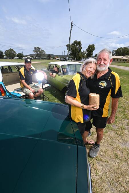 DRIVE TIME: Twin City Classic Vehicle Club is hosting a drive-in movie in Albury: Rhonda and Trevor Watt with president Nathan Maloney (Holden HJ station wagon) and rally coordinator Michael Quinn (EJ Holden lime green). Picture: MARK JESSER
