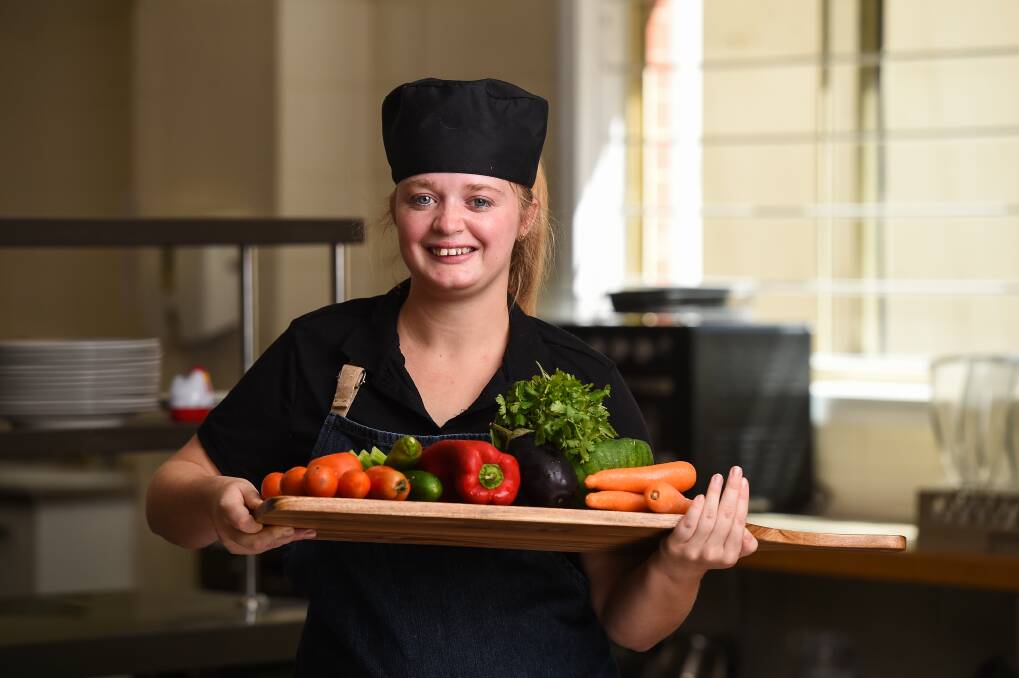 TEAM WORK: Thurgoona-based Hannah Clarke is relishing her role in the kitchen at Purple Chicken, a social enterprise designed to train and connect participants with the Border hospitality sector. Picture: MARK JESSER