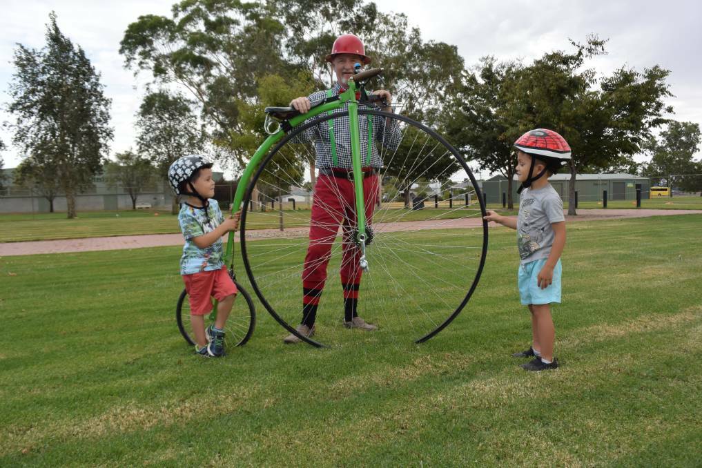 Wodonga youngster Lewis Buckley, 4, checks out David Hawkins' penny-farthing ahead of the Lake Hume Cycle Challenge this weekend.