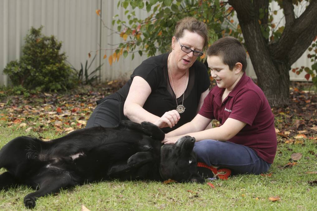 DOWN TIME: Wodonga disability advocate Jen Tait with her son Alec Tait-Russell and their dog at home in West Wodonga. Picture: ELENOR TEDENBORG