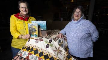 TEXTILE TRIBUTE: Wodonga Family History Society (WFHS) research officer Alice Lindsay and Wodonga quilter Leah Whale display the latter's tribute to the historic Rajah Quilt at the WFHS Library within Hyphen. Picture: ASH SMITH