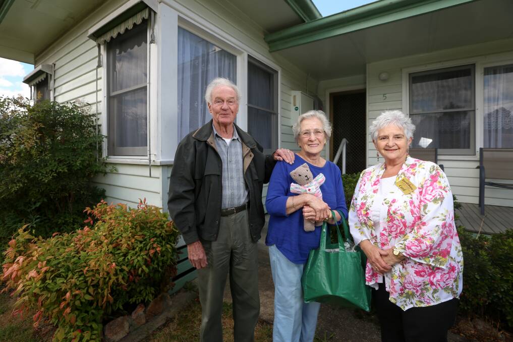 COMMUNITY SPIRIT: Corryong's Mr and Mrs Prime take delivery of a Christmas hamper from Corryong FoodShare coordinator Carol Allen as part of her deliveries this week. The couple say support from the community has been overwhelming. Pictures: JAMES WILTSHIRE