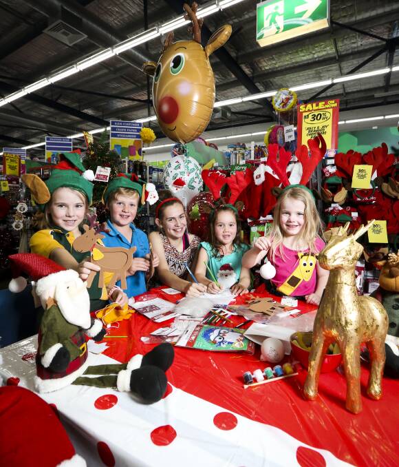 CREATIVE OUTLET: Vida Alexander, 7, Darcy Boland, 6, Jayda Wood, 11, Millie O'Keefe, 5, and Asha Alexander, 5, get into the festive spirit at Spotlight Albury. A Christmas party will be held on December 10. Picture: JAMES WILTSHIRE