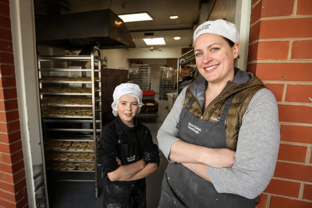 EARNING A CRUST: Beechworth baker Louise Ritchie, with son Ted, 9, in the Silver Creek Sourdough Bakery, which supplies more than a dozen shops with sourdough bread, crumpets and pizza bases. Picture: JAMES WILTSHIRE