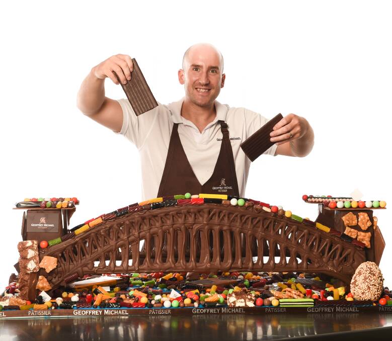 BUILD A BRIDGE: Geoffrey Michael Patissier will auction a chocolate Sydney Harbour Bridge to raise money for Cancer Council NSW. It took six hours to make and will go to the highest bidder before March 24. Picture: MARK JESSER