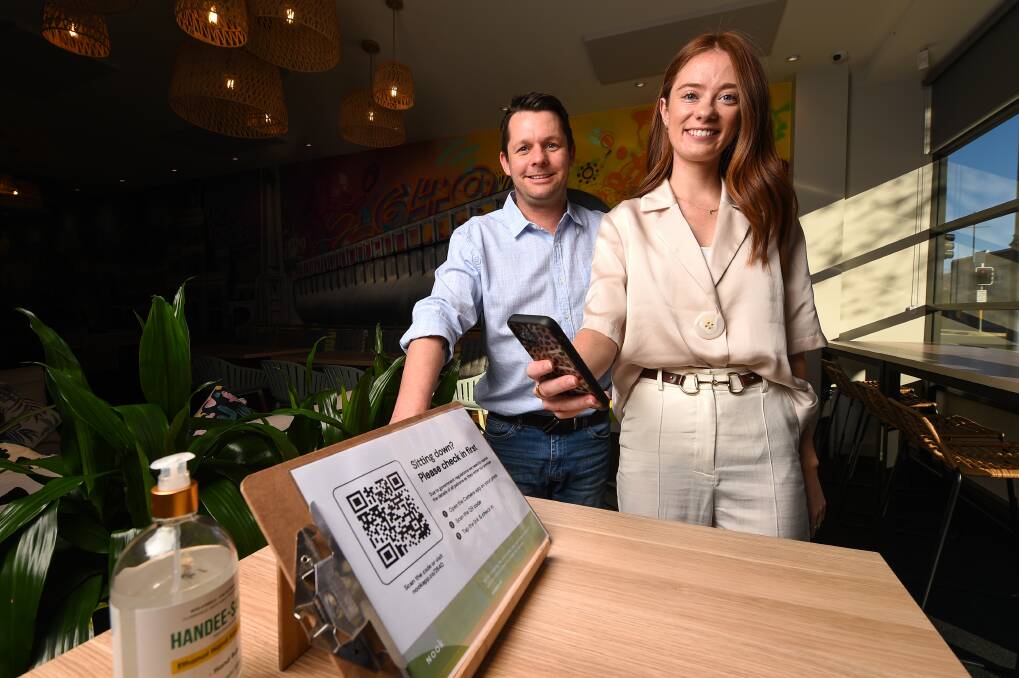 IN FOCUS: 2640 Restaurant and Bar owner Joel Carey and Nook co-creator Bella Chambers demonstrate the sign-in app at the Albury eatery. Picture: MARK JESSER