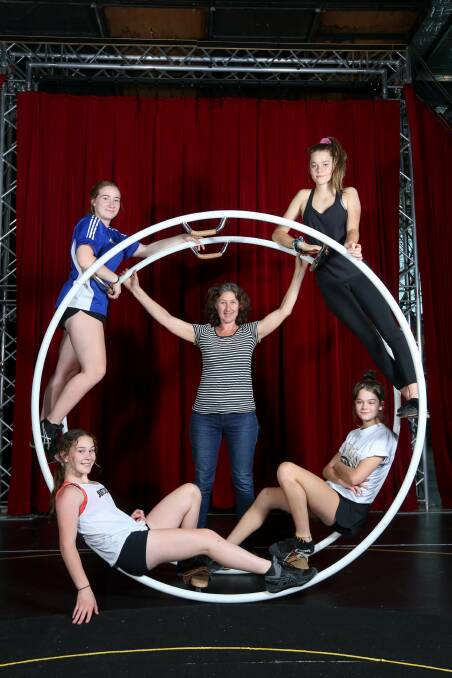 IN THE ROUND: Flying Fruit Fly Circus performers (clockwise from top left) Kezia Sutton, Bianca Hall, Natasha Hall and Kelsey Eckhardt with director Anni Davey, centre. Picture: TARA TREWHELLA
