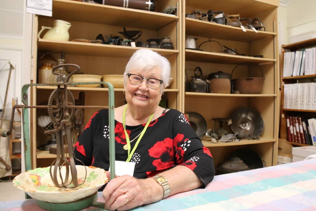 TIME LINES: Wodonga Historical Society president Marie Elliot showcases some of the vast collection at the society's new headquarters at Bonegilla Migrant Experience, which will open daily excluding Tuesday and Friday.