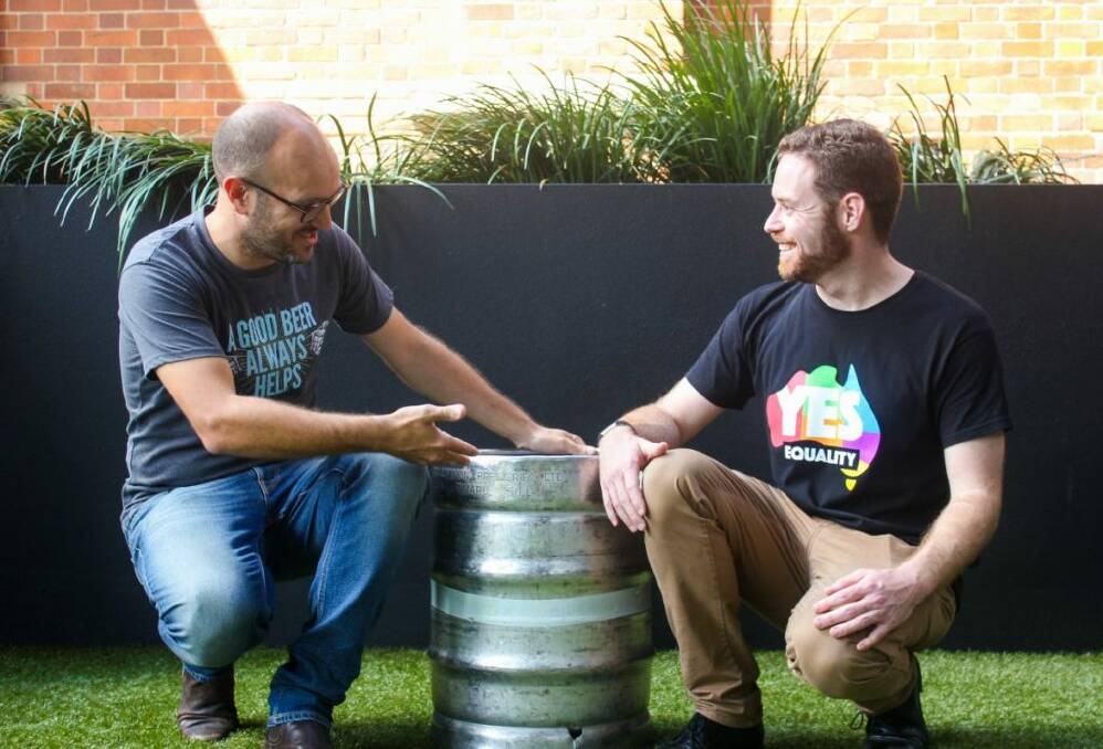 HERE'S CHEERS: The Good Beer Co founder James Grugeon and Peter Black, Queensland coordinator, Australian Marriage Equality Campaign with the Love2 brew. Picture: SAM MEHAN
 