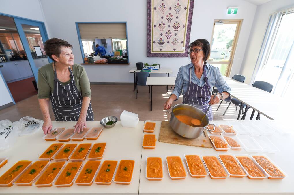 CARE FACTOR: Volunteers Maxine Neilson and Stella Phillips prepare emergency food at Birallee Park Neighbourhood House in Wodonga yesterday. Picture: MARK JESSER