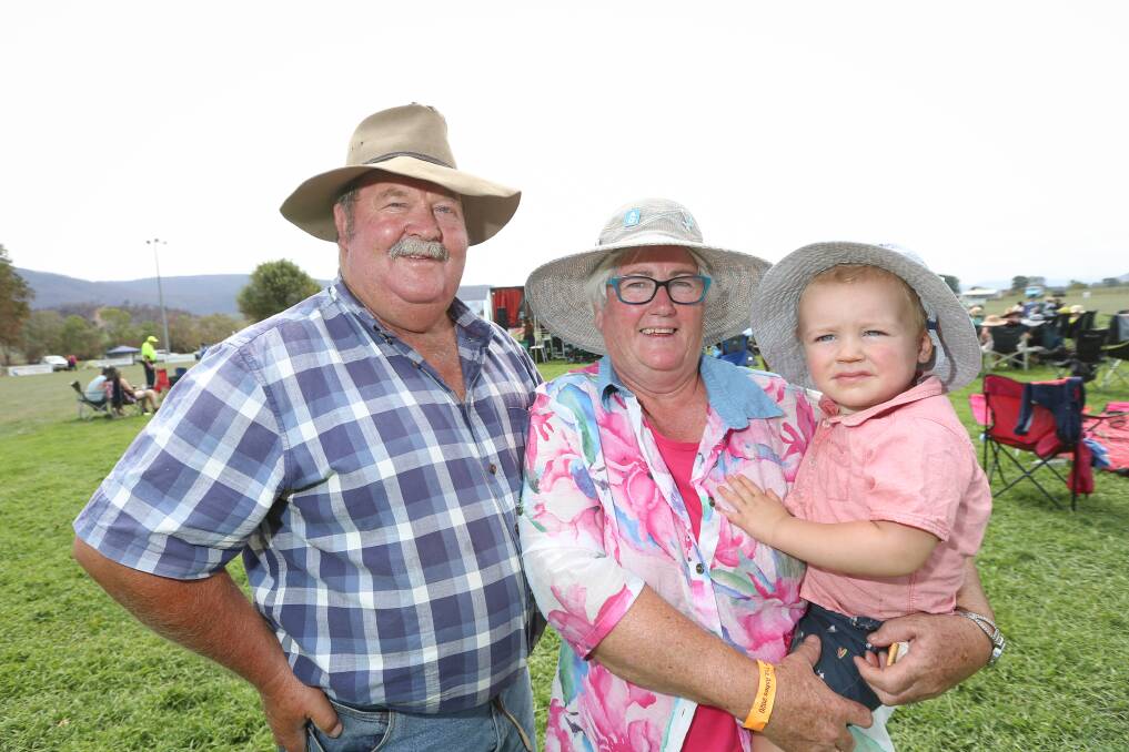 Cudgewa woolgrowers and cattle producers Greg and Alice Albert with their grandson, Cooper Albert, 2, at the Rise From The Ashes concert at Cudgewa in February.