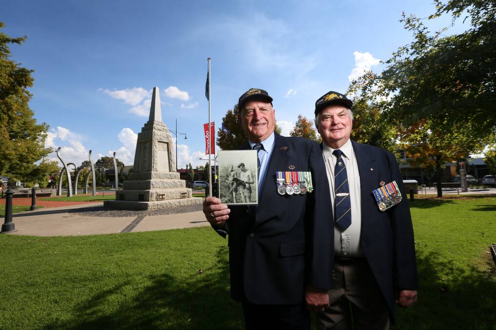 BYGONE ERA: Vietnam Veteran Ross Hore with a photo of himself and Eric Leask, who served together in 1966-67. Pictures: JAMES WILTSHIRE