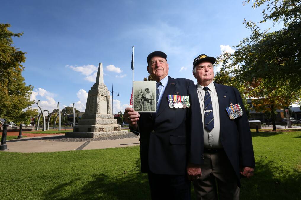 BYGONE ERA: Vietnam Veteran Ross Hore with a photo of himself and Eric Leask, who served together in 1966-67. Pictures: JAMES WILTSHIRE
