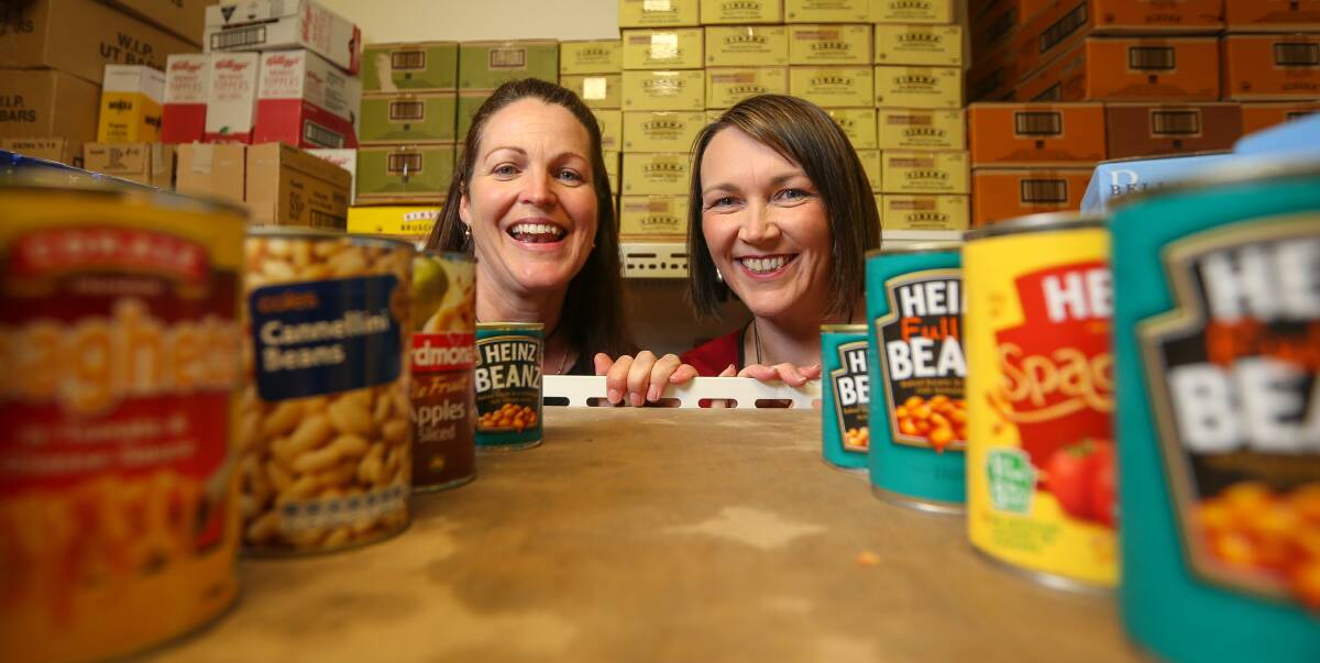 SURE CAN: UnitingCare Wodonga agency manager Naomi Jansen and Border woman Ainsley Stone hope Border businesses will embrace One Can Can in the nine-week countdown to Christmas. Picture: JAMES WILTSHIRE