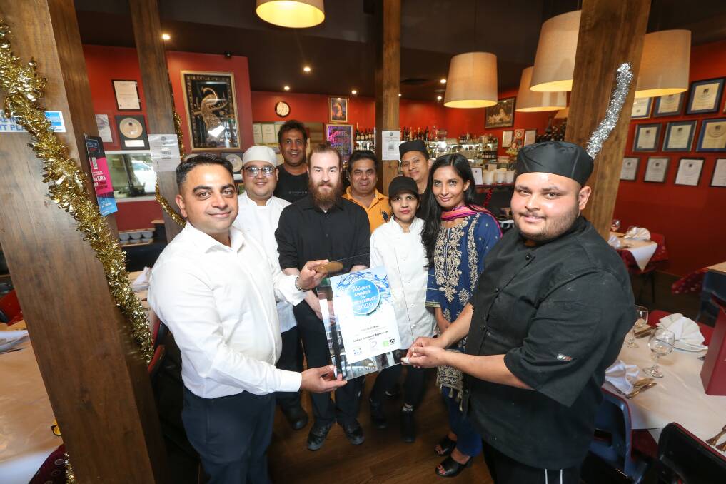 STATE AWARD: Indian Tandoori's Manraj Bhullar (back), his wife Naziya (second from right) and team with the award. Picture: JAMES WILTSHIRE