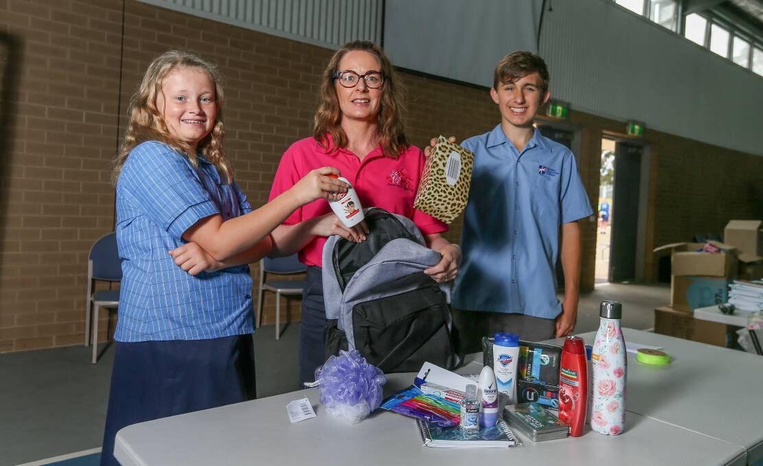 CHARITY DRIVE: Border Christian College students Erin Hetherington and Oscar Hetherington help Share the Dignity Riverina and Far West coordinator Rebecca O'Brien pack items for the It's In The Bag campaign, which runs until Sunday. Picture: TARA TREWHELLA
