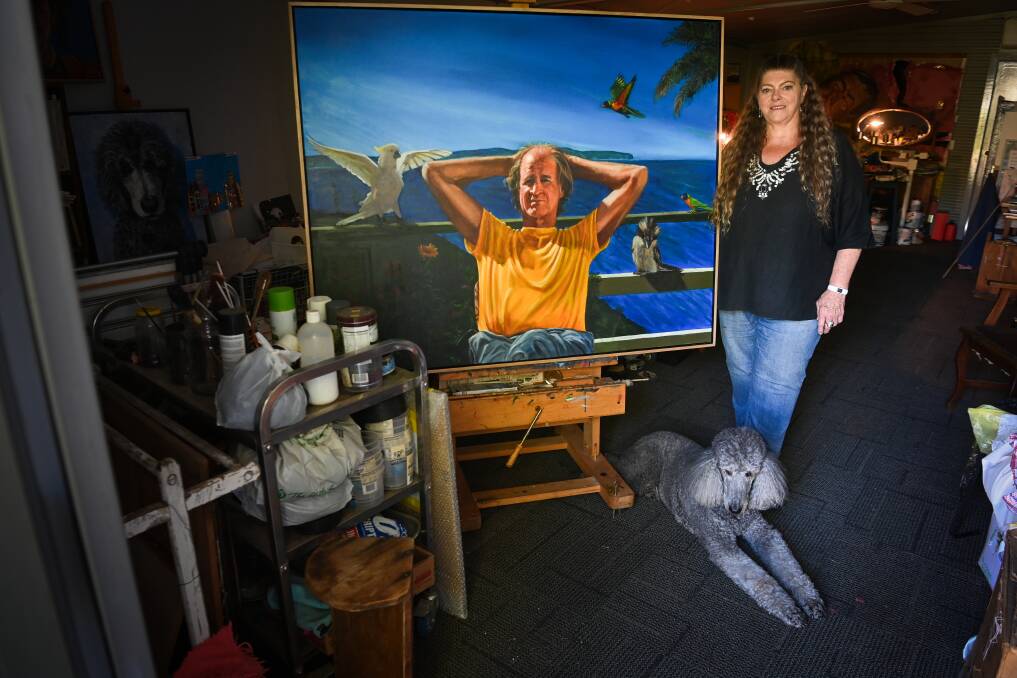 PEOPLE PERSON: North Albury artist MariJana van Zanten with her dog Ludo and her newly-completed Archibald Prize entry, James at Home, a portrait of Australian film director James Ricketson. Picture: MARK JESSER