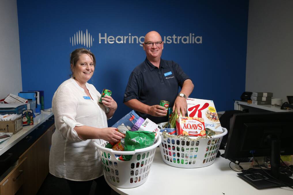 FAIR SHARE: Hearing Australia audiologists Kathryn Symes and Graham Daglish with the items going to FoodShare. Picture: JAMES WILTSHIRE