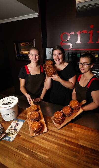 CHEW OVER: Grind on Olive staff Meg Whitelaw, Sally Whyte and Shaynee Otto sell Anzac biscuits on Friday with all proceeds to Legacy. Picture: JAMES WILTSHIRE