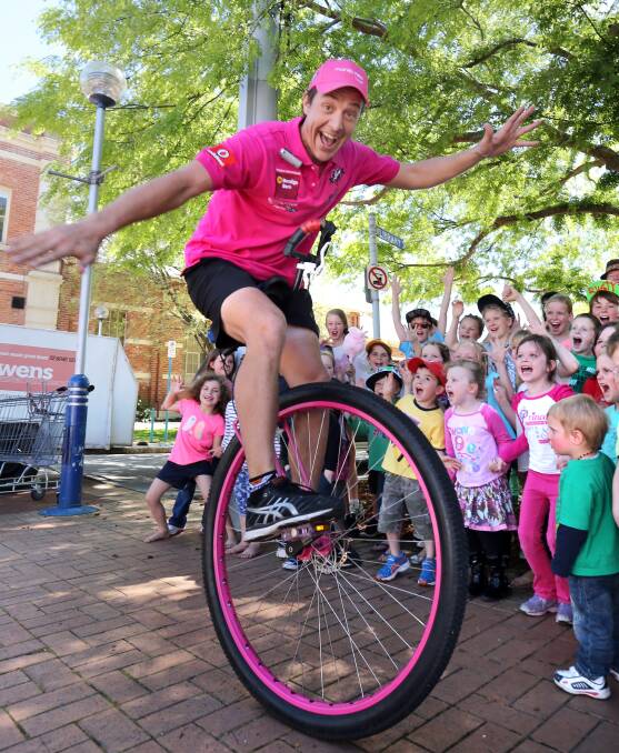 TICKET TO RIDE: Samuel Johnson shows children in Albury in September 2013 how he stays on his unicycle during his epic 15,000-kilometre ride around Australia.