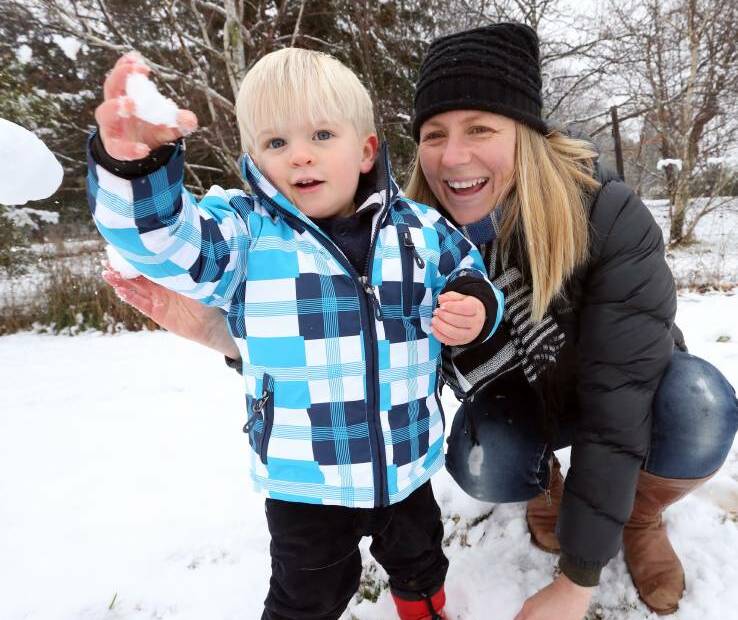 HAVING A BALL: Rachel Kerkvliet and her son Charlie Brown, 2, play in the snow that covered Stanley in the early hours of Wednesday morning. Up to 10 centimetres of snow fell in the village. Picture: John Russell