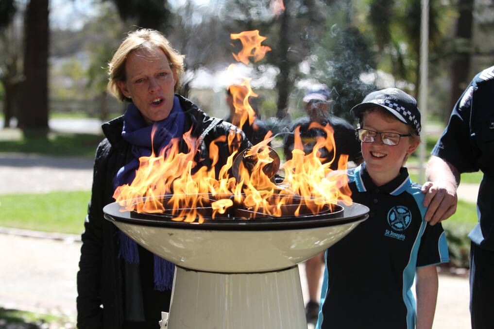 WALKING TALL: St Joseph’s Primary School students, Victoria Police and Special Olympics members took the torch run down Beechworth's Church Street on Wednesday. Pictures: SHANA MORGAN