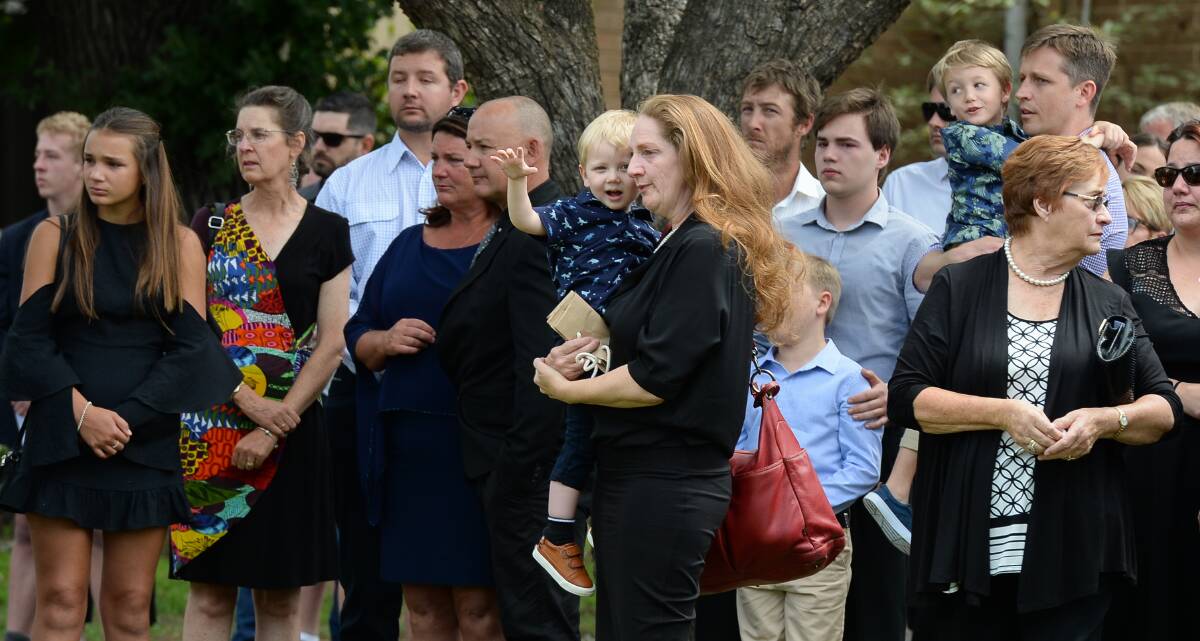 HEARTBREAKING DAY: Amanda Kilmister's father Noel Gwynne gave a moving tribute for mourners at the funeral on Monday, before comforting his grandsons outside at Wangaratta's Holy Trinity Cathedral. Pictures: MARK JESSER