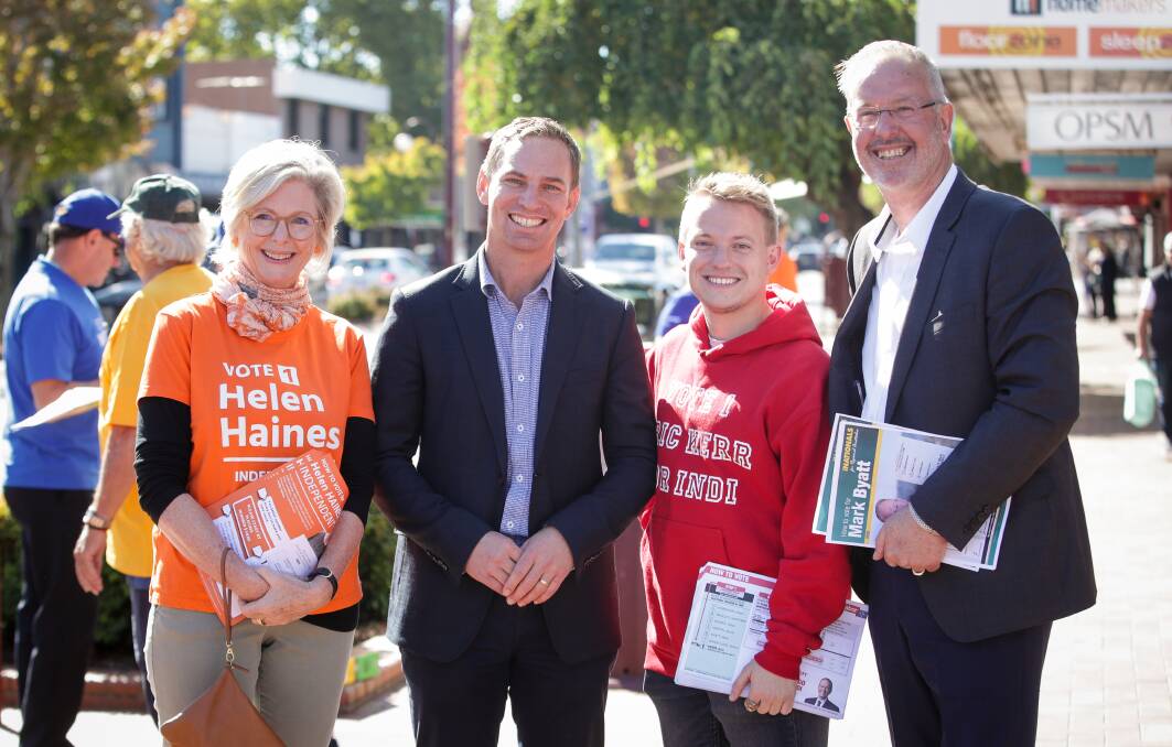 SHOWING THEIR COLOURS: Candidates Helen Haines, Steve Martin, Eric Kerr and Mark Byatt joined volunteers at the Wangaratta early voting centre on Monday. Pictures: JAMES WILTSHIRE