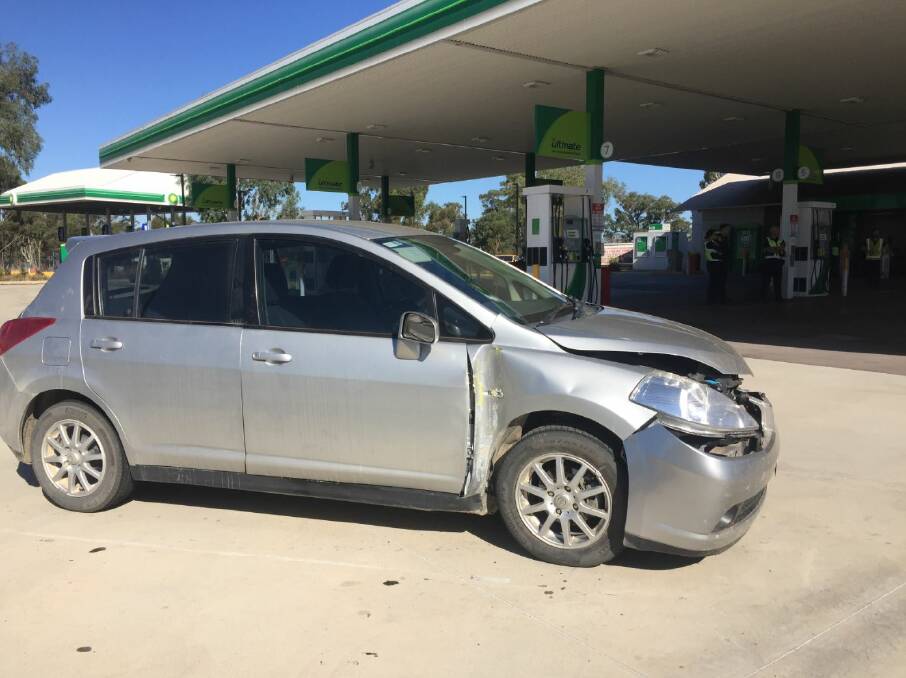 DESTRUCTION: This Nissan Tiida was one of at least four private cars damaged during a driving rampage at a Hume Freeway petrol station on Thursday.